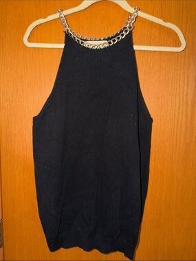 MICHAEL Michael Kors VINTAGE (Category: Luxury Apparel) located in Manila. Submitted by icamalicdem29 (Listing ID 1468838768, Image 2). Description: MICHAEL Michael Kors black knit halter top featuring a prominent gold-tone chain-link neckline. It is a sleeveless, high-neck piece made from a ribbed knit fabric that creates a sophisticated, jewelry-accented style suitable for transitioning from day to evening wear..