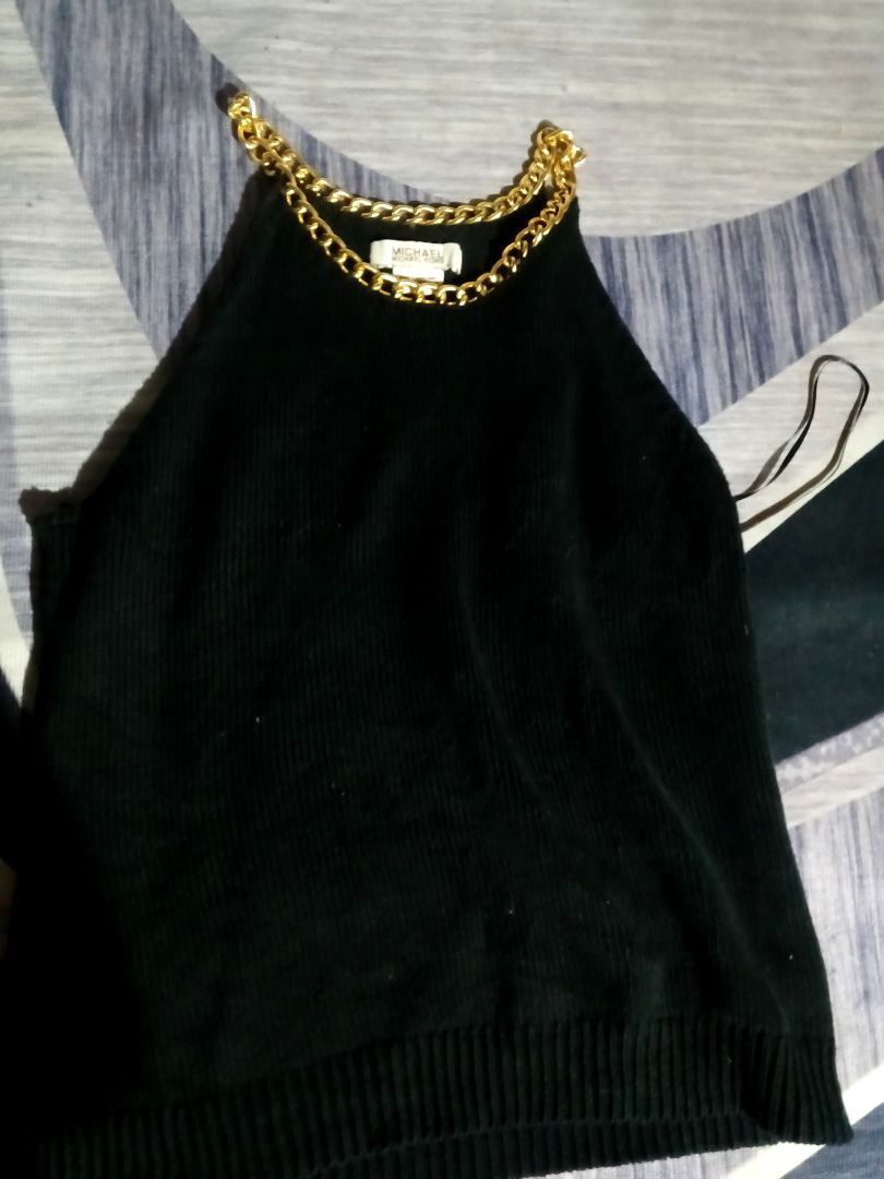 MICHAEL Michael Kors VINTAGE (Category: Luxury Apparel) located in Manila. Submitted by icamalicdem29 (Listing ID 1468838768, Image 3). Description: MICHAEL Michael Kors black knit halter top featuring a prominent gold-tone chain-link neckline. It is a sleeveless, high-neck piece made from a ribbed knit fabric that creates a sophisticated, jewelry-accented style suitable for transitioning from day to evening wear..
