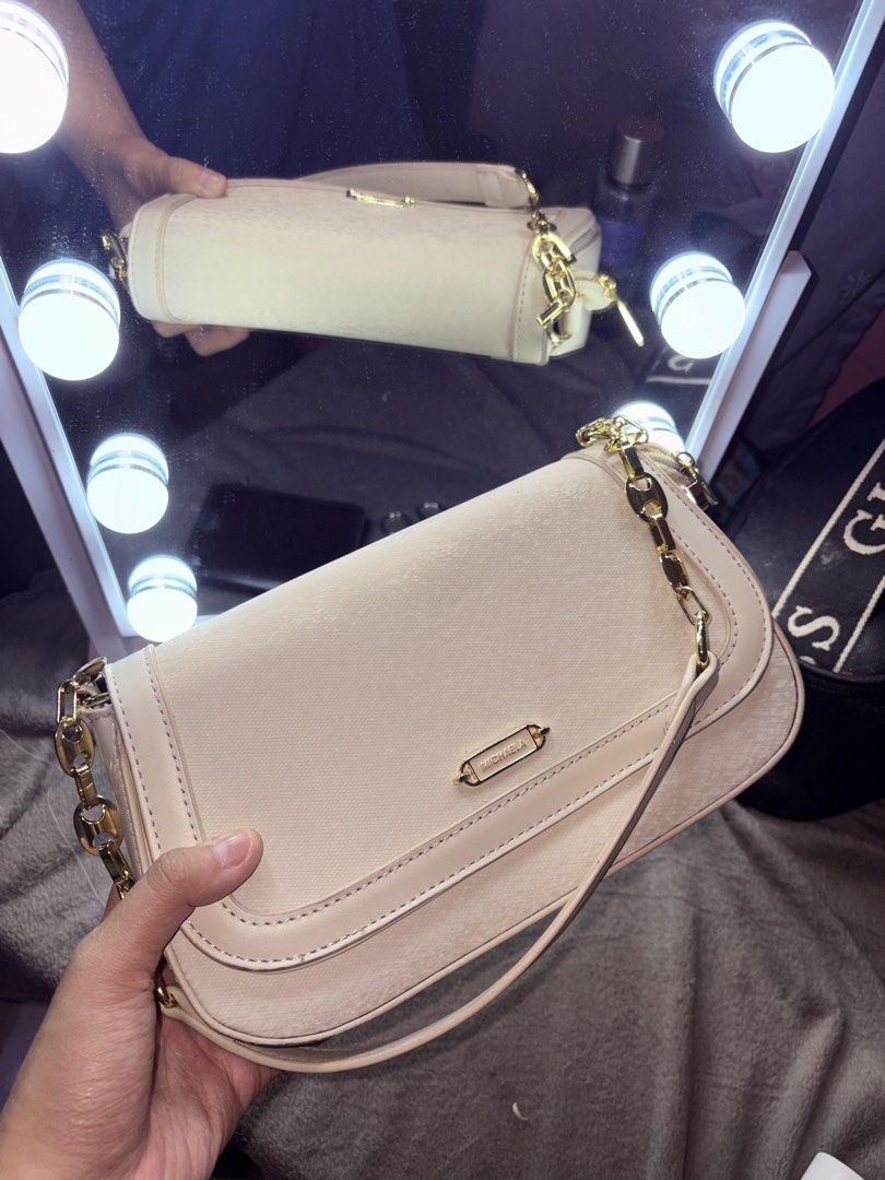 MICHAELA beige textured shoulder bag with gold chain (Category: Shoulder Bags) located in Manila. Submitted by rexibuys (Listing ID 1468881473, Image 1). Description: - Brand: MICHAELA - Color: Classic Beige - Material: Textured faux leather with gold-tone hardware - Closure: Flap with magnetic snap buttons - Interior: Zipped compartments for easy organization - Strap: Chunky chain strap with a comfortable leather shoulder rest (comes with sling 