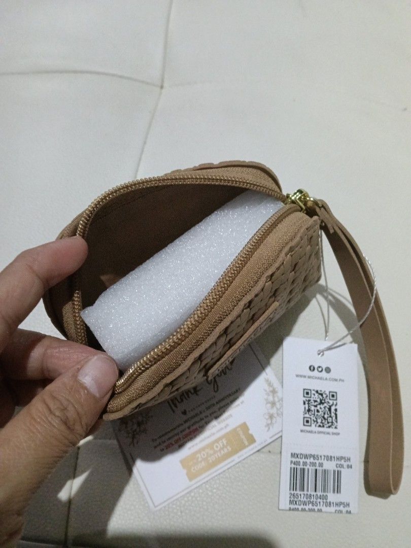 MICHAELA Woven Wristlet Pouch Beige (Category: Clutches) located in Manila. Submitted by zenbear_6b2d8a (Listing ID 1468811581, Image 2). Description: - Brand: MICHAELA - Style: Woven wristlet pouch - Color: Beige - Condition: Brand new, never used (foam insert still intact) - Features: Compact size, wrist strap, secure zip closure - Inclusions: Original hang tag and thank you card.