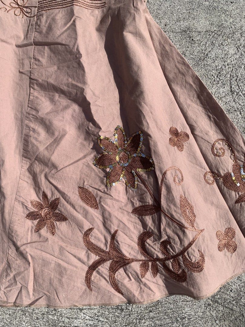 midi skirt with embroidery (Category: Skirts) located in Muntinlupa City. Submitted by pink.poppies (Listing ID 1468774818, Image 3). Description: - Color/Design: Pink midi skirt with intricate brown floral embroidery along the hem - Waistband: Wide, detailed waistband with a mid-rise fit - Special Details: Subtle silver sequins on the main flower motifs - Fit/Material: Lightweight fabric with a flattering flared silhouette - Condition: Excellent