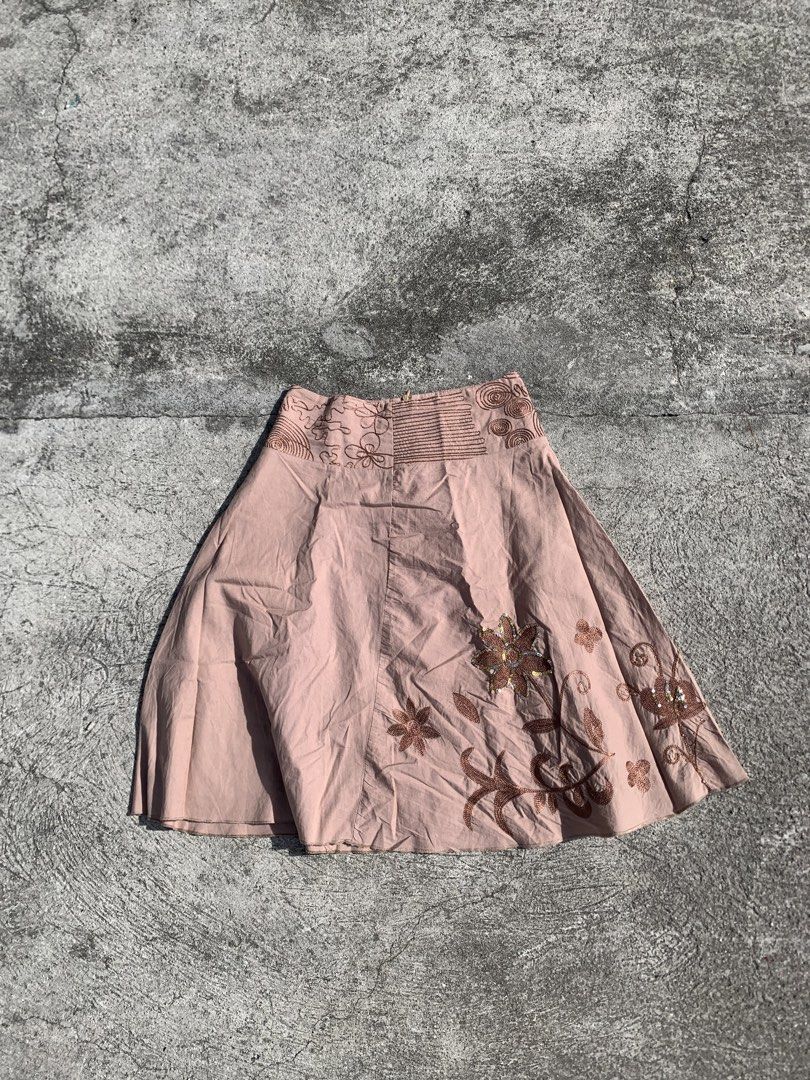 midi skirt with embroidery (Category: Skirts) located in Muntinlupa City. Submitted by pink.poppies (Listing ID 1468774818, Image 1). Description: - Color/Design: Pink midi skirt with intricate brown floral embroidery along the hem - Waistband: Wide, detailed waistband with a mid-rise fit - Special Details: Subtle silver sequins on the main flower motifs - Fit/Material: Lightweight fabric with a flattering flared silhouette - Condition: Excellent