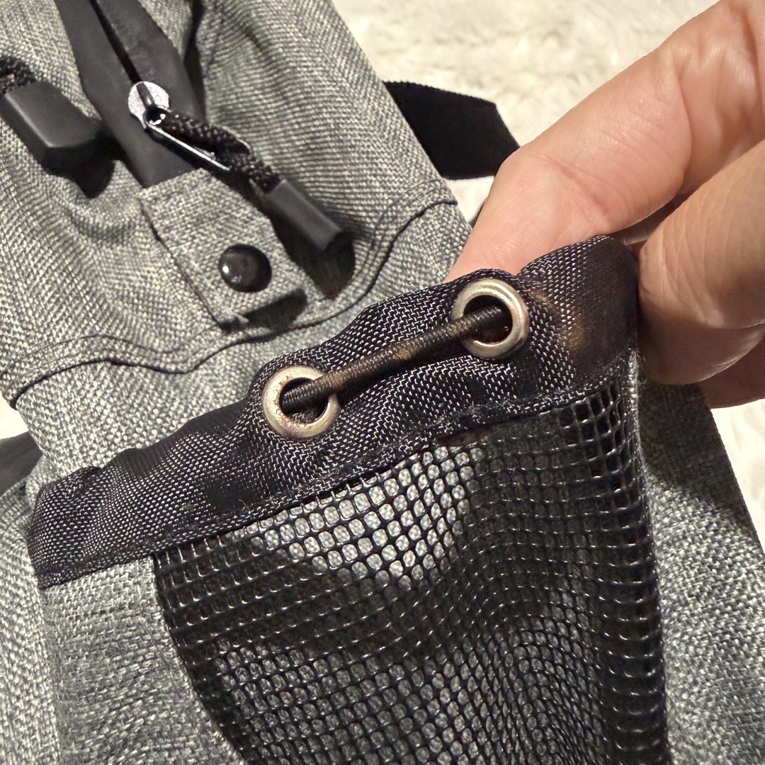 Mini Banff Grey Backpack (Category: Backpacks) located in Pasig City. Submitted by mommy_n_me_closet (Listing ID 1468792741, Image 3). Description: - Colour: Grey heathered with Banff embroidery - Interior: Bright red lining with built-in organizer compartments - Exterior: Secure zipped pockets, top grab handles, and adjustable shoulder straps - Extras: Side mesh pockets equipped with drawstring cords - Condition: Some slight staining visible aro