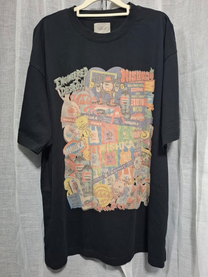 Mishka Black Graphic Tee (Category: Tshirts & Polo Shirts ) located in Manila. Submitted by jazil.ladyliz (Listing ID 1468924984, Image 3). Description: - Brand: Mishka - Style: Graphic t-shirt with bold pop culture and street art collage print - Color: Black - Dimes: 25x31.5 - Material: 100% soft, comfortable cotton - Details: Rubber patch label at the lower back hem.