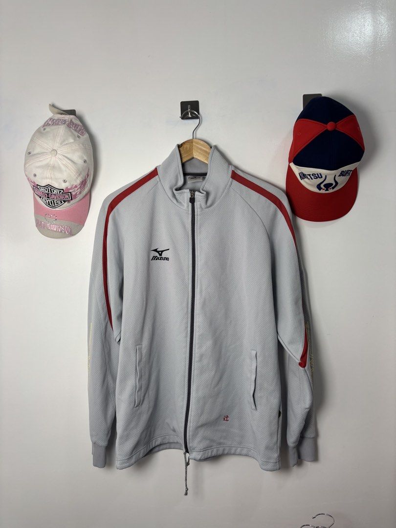 Mizuno Grey Track Jacket With Red Accents (Category: Coats, Jackets and Outerwear) located in Calbayog City. Submitted by zaxcheus_castillo1708 (Listing ID 1468752313, Image 1). Description: - Brand: Mizuno - Color: Grey with striking red piping along shoulders and sleeves - Design: Full zip front, mock neck collar, and unique red Japanese character embroidered near the bottom hem - Features: Two functional side pockets and comfortable ribbed cuf