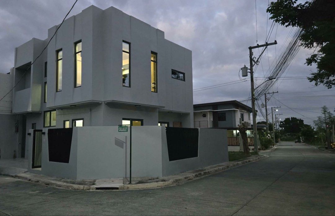 FOR SALE: MODERN MINIMALIST HOUSE and LOT (Category: Bed Frames & Mattresses) located in Angeles City. Submitted by tatasexy_24 (Listing ID 1468517973, Image 3). Description: - Style: Clean minimalist design in neutral gray tones with abundant natural light - Bedroom: Includes a spacious gray bed frame, matching sectional sofa, and sleek concrete-look flooring - Windows: Fitted with modern roller blinds - Bathroom: Features a luxurious freestandi