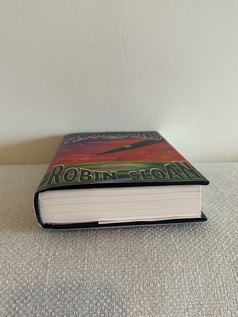 Moonbound by Robin Sloan Hardcover Novel (Category: Storybooks) located in Pasig City. Submitted by cosmicjuice08 (Listing ID 1468737856, Image 2). Description: - Title: Moonbound by Robin Sloan - Edition: Hardcover with vibrant celestial dust jacket - Series: Part of the Penumbraverse - Condition: Pristine white pages inside, never read - Source: Bought locally from Fully Booked (original price sticker on back cover) - Genre: Great addition for 