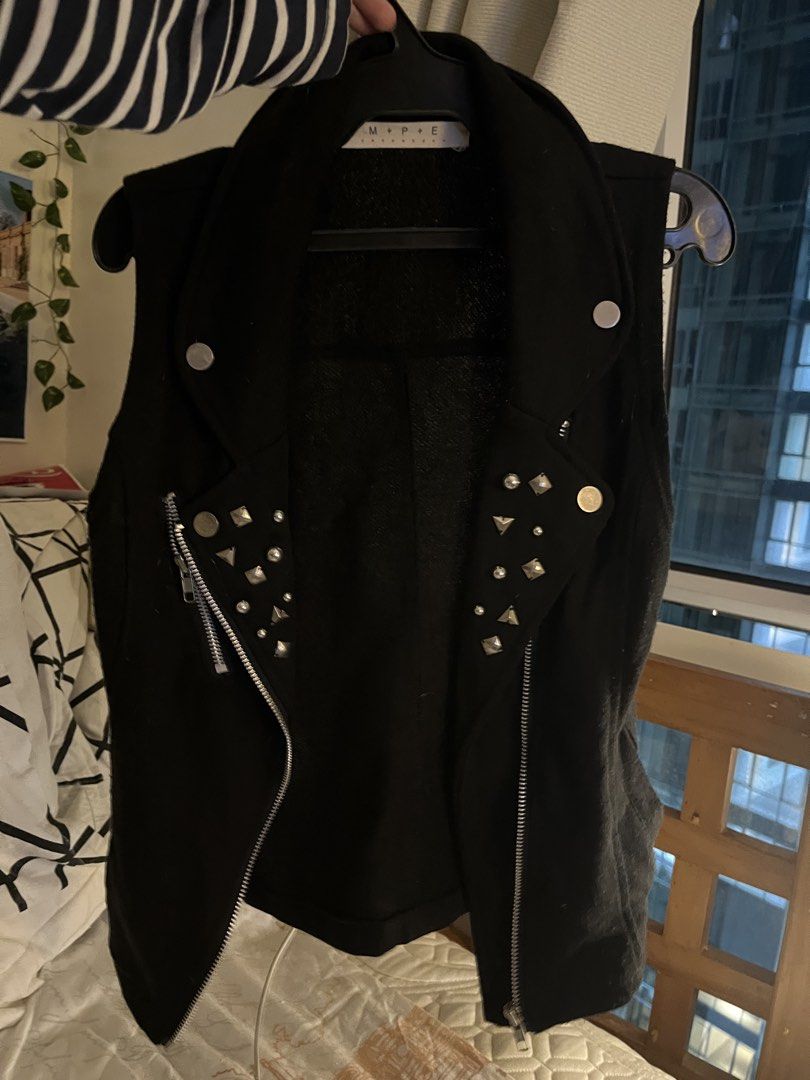 M+P+E Black Studded Biker Vest (Category: Coats, Jackets and Outerwear) located in Quezon City. Submitted by toasterpiee (Listing ID 1468884105, Image 1). Description: - Brand/Model: M+P+E black sleeveless biker vest - Material: Heavyweight cotton or fleece for a durable feel - Design: Asymmetric front zipper with striking silver hardware - Detailing: Lapels decorated with edgy metal studs and spikes - Style: Rocker, punk, and biker aesthetic - C