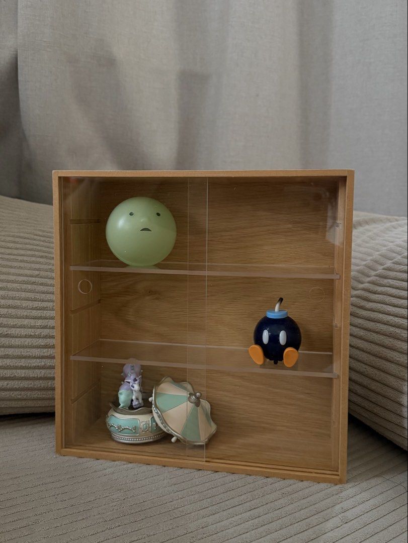 MUJI Wooden Collection Stand with Pull Door (Category: Shelves, Cabinets & Racks) located in Mandaluyong City. Submitted by mockinqjay (Listing ID 1468781035, Image 1). Description: - Authentic MUJI wooden collection stand - Features clear, scratch-free transparent sliding doors - Compact size: roughly 10.9 x 3.3 x 10.9 inches - Removable shelves for customizable spacing - Ideal for miniature figures, small collectibles, and trinkets (Smiskis, So