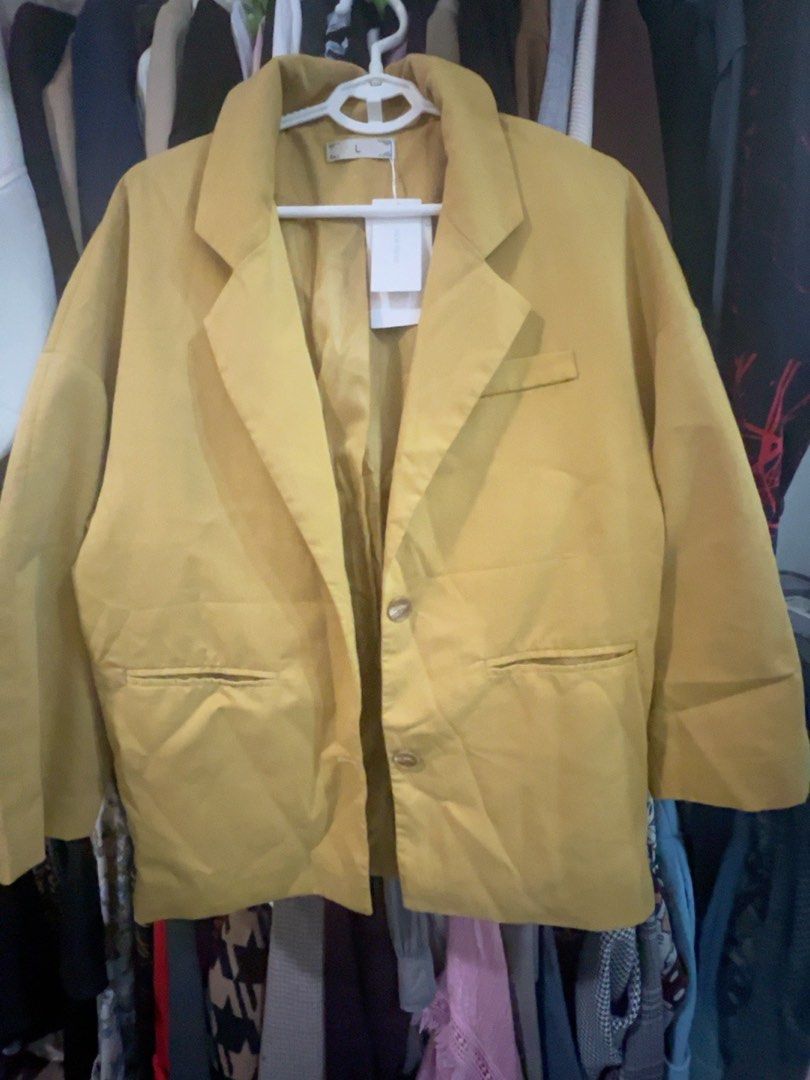 Mustard Yellow Oversized Casual Blazer Size L (Category: Coats, Jackets and Outerwear) located in Quezon City. Submitted by kishey (Listing ID 1468777779, Image 2). Description: - Color: Mustard yellow - Bust: 46 inches - Length: 27 inches - Details: Structured lapels, two front button closures, functional flap pockets - Condition: Brand new with original tag attached - Interior: Fully lined.