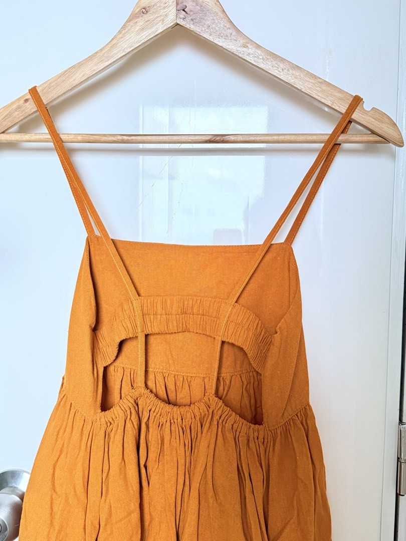 Mustard Yellow Spaghetti Strap Backless Linen Dress (Category: Dresses) located in Quezon City. Submitted by ynnapenyaranda (Listing ID 1468871123, Image 2). Description: - Color: Mustard yellow - Length: Midi - Neckline: Square neck with delicate double straps - Details: Smocked back cutout and gathered tiered skirt - Fit: Pullover design with a stretchy back panel for easy wear - Fabric: Lightweight and comfortable, ideal for sunny days and cas