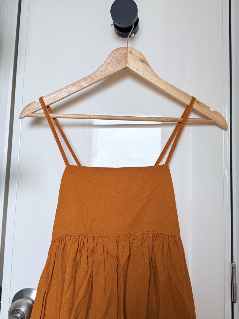 Mustard Yellow Spaghetti Strap Backless Linen Dress (Category: Dresses) located in Quezon City. Submitted by ynnapenyaranda (Listing ID 1468871123, Image 3). Description: - Color: Mustard yellow - Length: Midi - Neckline: Square neck with delicate double straps - Details: Smocked back cutout and gathered tiered skirt - Fit: Pullover design with a stretchy back panel for easy wear - Fabric: Lightweight and comfortable, ideal for sunny days and cas