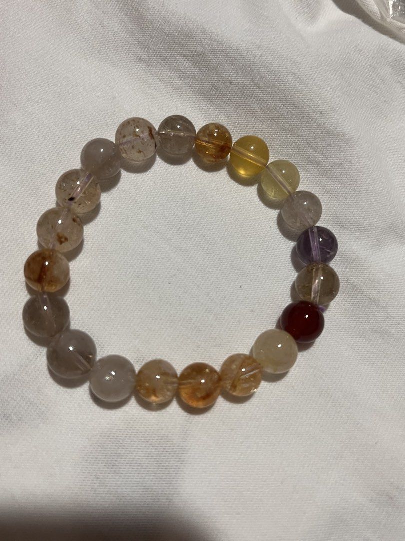 Natural Crystal Bracelet for with Gemstone Identification Certificate (Category: Bracelets) located in Legazpi City. Submitted by sandras. (Listing ID 1468769945, Image 2). Description: - Stunning multicolor natural crystal bracelet with quartz beads - Features a beautiful mix of yellow, purple, clear, and a dark red accent bead - Total weight: 17.73g - Showcases unique natural inclusions inside the stones - Includes official jewelry testing cert