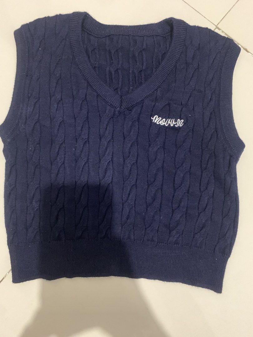 Navy Blue Cable Knit V-Neck Sweater Vest (Category: Sleeveless) located in Manila. Submitted by mixwearclosetclothingstore (Listing ID 1468888607, Image 1). Description: - Color: Navy blue with white embroidered lettering - Material: Soft, comfortable cable knit fabric - Design: Classic V-neck with ribbed hem and armholes - Styling: Great for layering or wearing on its own - Versatile: Easy to match with skirts or trousers.