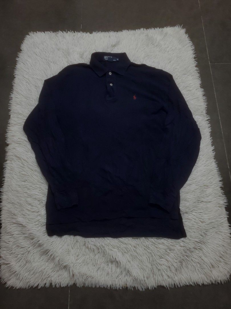Navy Blue Long Sleeve Polo Sweater (Category: Longsleeves) located in Manila. Submitted by royalrabbit.7b2a11 (Listing ID 1468814643, Image 1). Description: - Color: Navy blue - Style: Long sleeve polo sweater with button placket and classic collar - Details: Small embroidered logo on the chest, ribbed cuffs and hem - Fit: Standard fit - Fabric: Comfortable knit, ideal for layering in cooler weather.