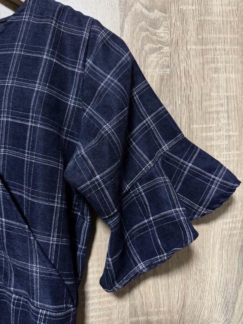 Navy Blue Plaid Midi Dress (Category: Dresses) located in Bulacan. Submitted by relove.re (Listing ID 1468719961, Image 3). Description: Elegant and classy with a timeless plaid pattern! 💙 Size: XS to S ✔️ Navy blue with white checkered design ✔️ Flattering V-neckline ✔️ Stylish flutter sleeves ✔️ Defined waist for a feminine silhouette ✔️ Tiered skirt for a flowy, graceful look ✔️ Back zipper closure Perfect for casual outings, office wear, chu