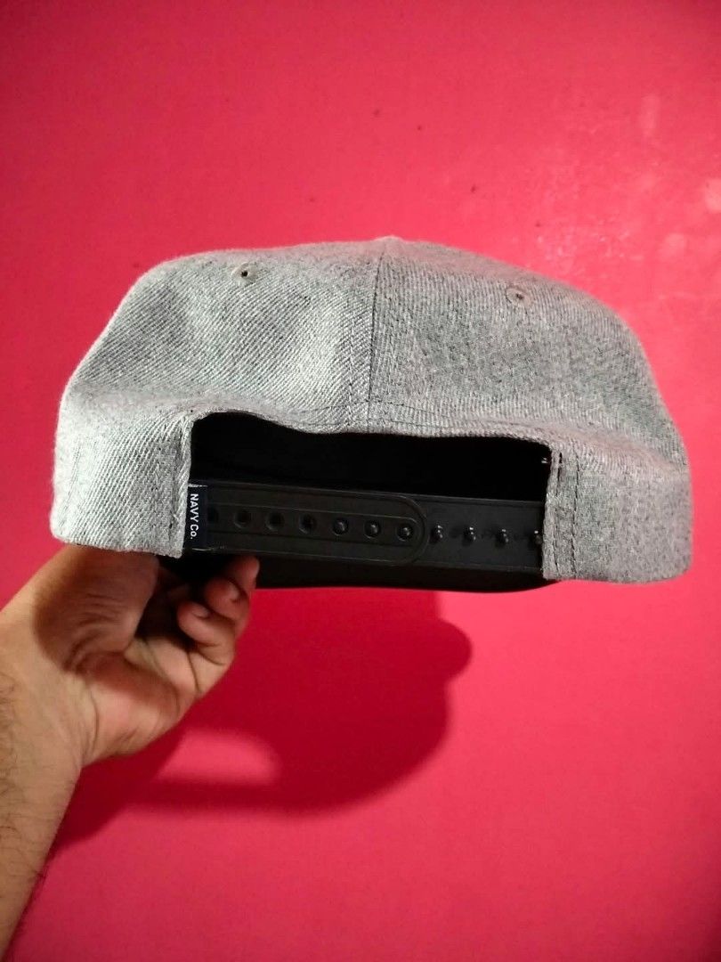 Navy Co. Friday The 13th Snapback Cap (Category: Caps & Hats) located in Mangaldan. Submitted by niftythrifty69 (Listing ID 1468734233, Image 2). Description: - Brand: Navy Co. - Design: Grey and black snapback with embroidered Friday The 13th patch and red 3 - Material: 100% cotton - Fit: Adjustable plastic strap at the back - Condition: Structured crown with a clean interior sweatband - Perfect for horror movie fans and everyday streetwear.