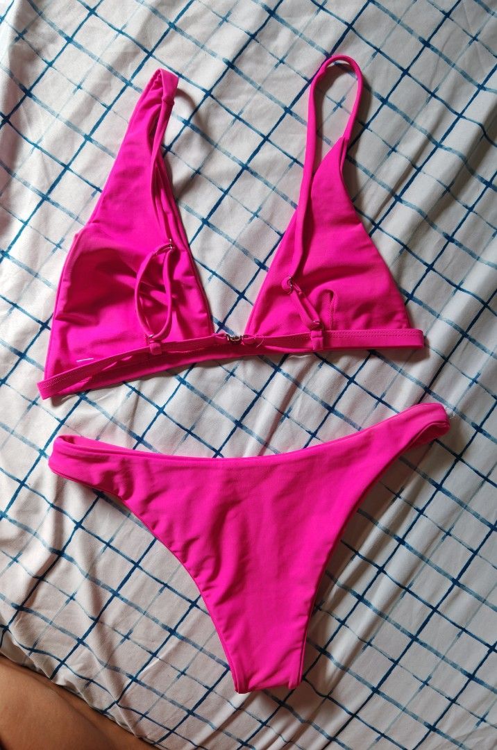 Neon Pink Textured Bikini Set (Category: Bikinis & Swimsuits) located in Paranaque City. Submitted by MLandCobyApple (Listing ID 1468758700, Image 2). Description: - Color: Bright hot pink - Material: Textured waffle-knit fabric with smooth inner lining - Top: Split center design, adjustable straps, clasp back - Bottoms: High-cut leg fit - Ideal for: Beach days, pool parties, and vacations.