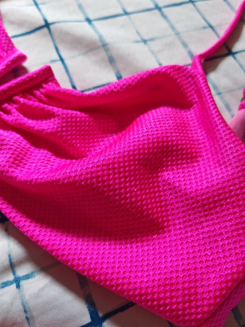 Neon Pink Textured Bikini Set (Category: Bikinis & Swimsuits) located in Paranaque City. Submitted by MLandCobyApple (Listing ID 1468758700, Image 3). Description: - Color: Bright hot pink - Material: Textured waffle-knit fabric with smooth inner lining - Top: Split center design, adjustable straps, clasp back - Bottoms: High-cut leg fit - Ideal for: Beach days, pool parties, and vacations.