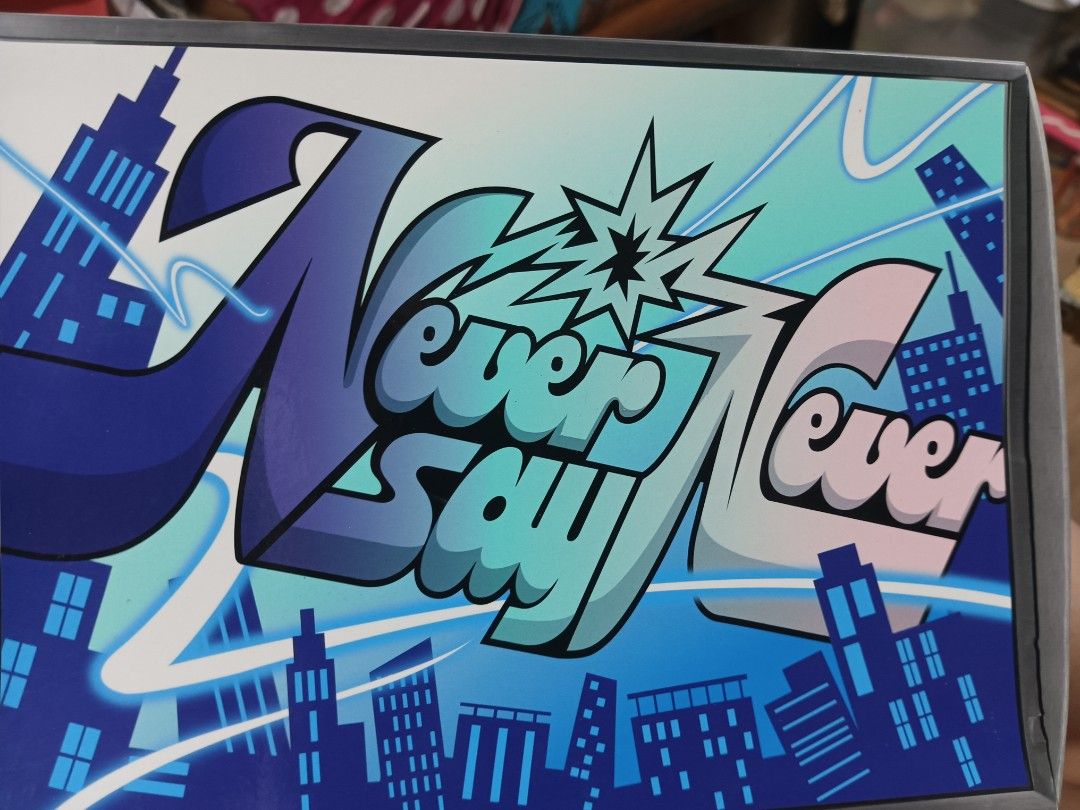 Never Say Never Comic Graffiti Graphic Box (Category: Comics & Manga) located in Manila. Submitted by laydeemoonrcl (Listing ID 1468795002, Image 1). Description: As is, Unsealed - Design: Fun comic-style graphic box featuring bold 'Never Say Never' graffiti typography against a city skyline backdrop - Color Scheme: Stylish blue and teal with sharp outlines - Function: Sturdy storage box design - Ideal For: Collectors or as cool room decor - Cond