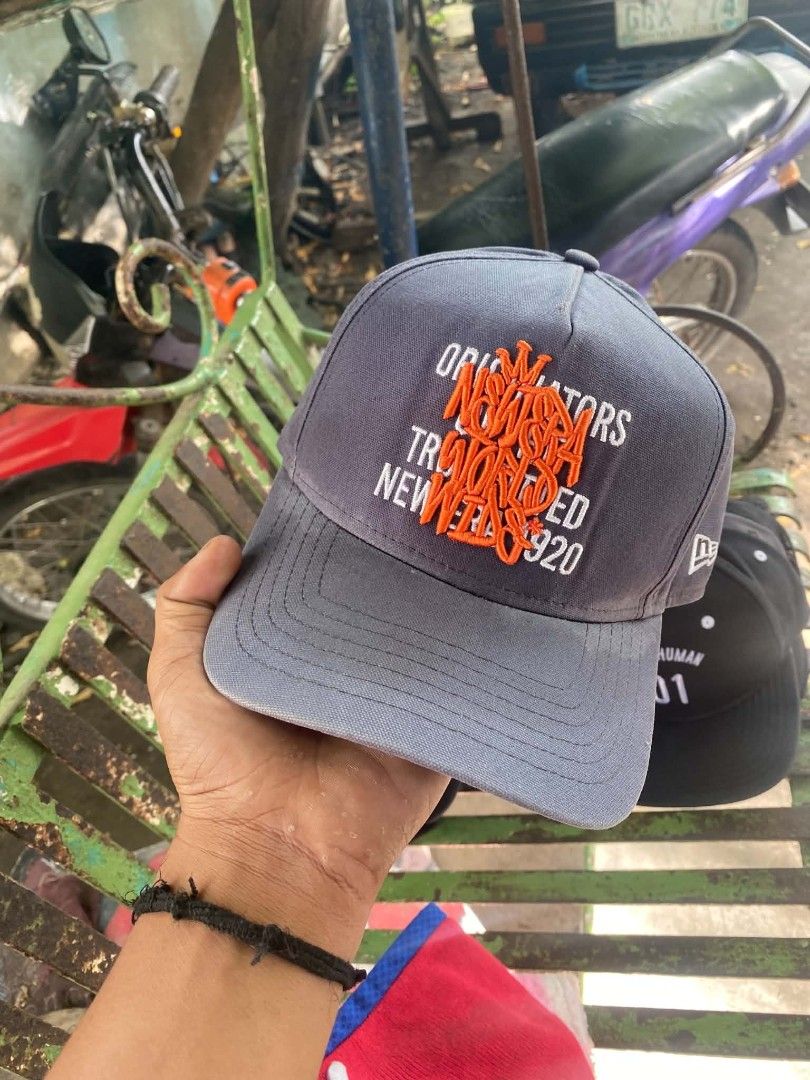New Era 920 Grey Orange Embroidered Cap (Category: Caps & Hats) located in Sibulan. Submitted by thethiftedcap0728 (Listing ID 1468735147, Image 1). Description: - Authentic New Era 920 cap in classic grey - Bold orange embroidered text on the front panel - Adjustable strapback closure with a durable metal buckle - Size: S/M with official interior branding and seams.