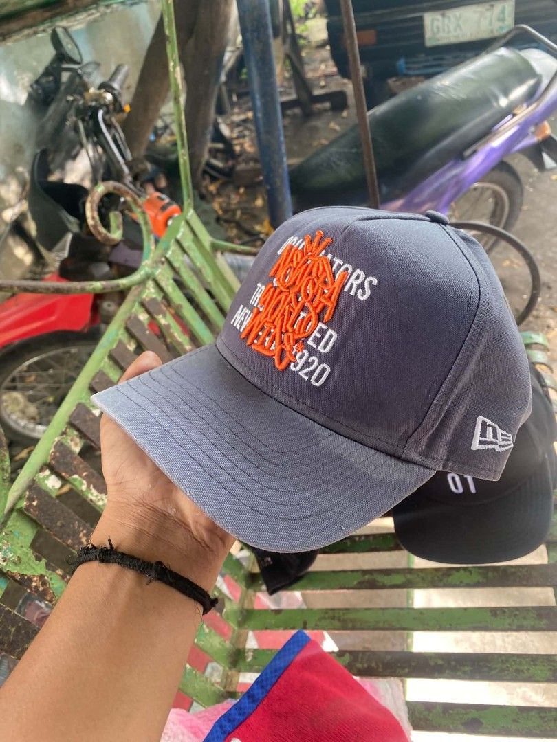 New Era 920 Grey Orange Embroidered Cap (Category: Caps & Hats) located in Sibulan. Submitted by thethiftedcap0728 (Listing ID 1468735147, Image 2). Description: - Authentic New Era 920 cap in classic grey - Bold orange embroidered text on the front panel - Adjustable strapback closure with a durable metal buckle - Size: S/M with official interior branding and seams.