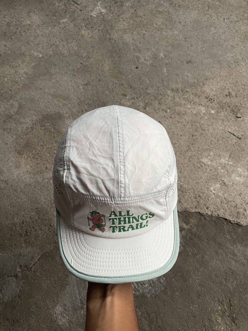 Nice Mac Club Bear Trail Camp 5-Panel Cap (Category: Caps & Hats) located in General Santos City (Dadiangas). Submitted by christbluee (Listing ID 1468827467, Image 2). Description: - Brand: Nice Mac Club - Style: White 5-panel cap with light green brim - Front Design: 'ALL THINGS TRAILS!' text and cute cartoon character - Side Details: 'BEAR TRAIL CAMP' text and large perforated 'NMC' lettering - Closure: Adjustable bungee cord toggle at the bac