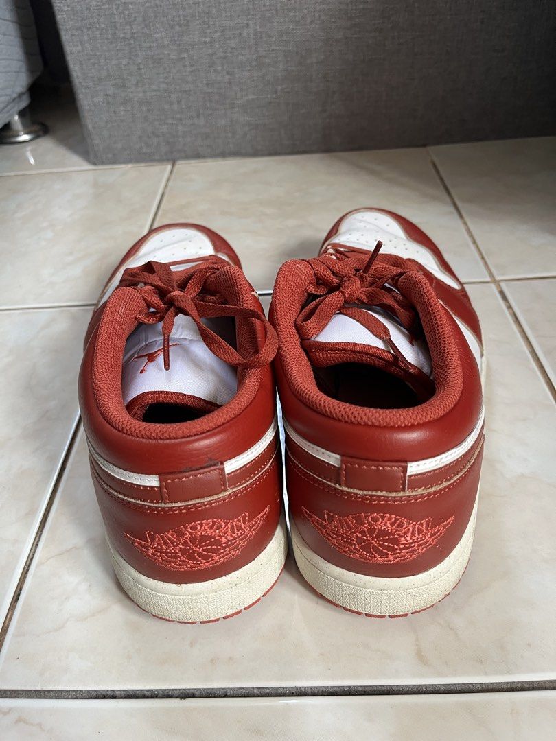 Nike Air Jordan 1 Low Red White (Category: Sneakers) located in Makati City. Submitted by ojala (Listing ID 1468743862, Image 3). Description: - Red and white leather low-top sneakers - Classic court style with signature wing logo embroidered on the heel - Minor creases on the toe box from previous wear - Soles show light dirt, but tread remains solid - Laces match the striking red overlays.