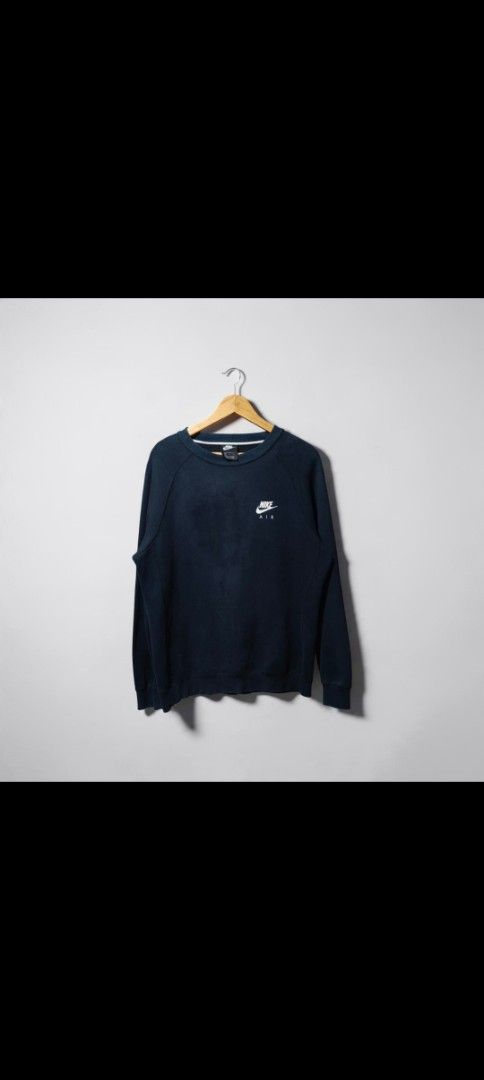 Nike Air Navy Blue Sweatshirt (Category: Coats, Jackets and Outerwear) located in Bulacan. Submitted by adrian2325 (Listing ID 1468783419, Image 1). Description: - Brand: Nike Air - Color: Navy Blue - Size: Large - Design: Small logo on front, big logo hit on back - Style: Comfortable pullover - Condition: Fabric shows fading and minor wear/small fraying around sleeve cuffs - Origin: Made in China.