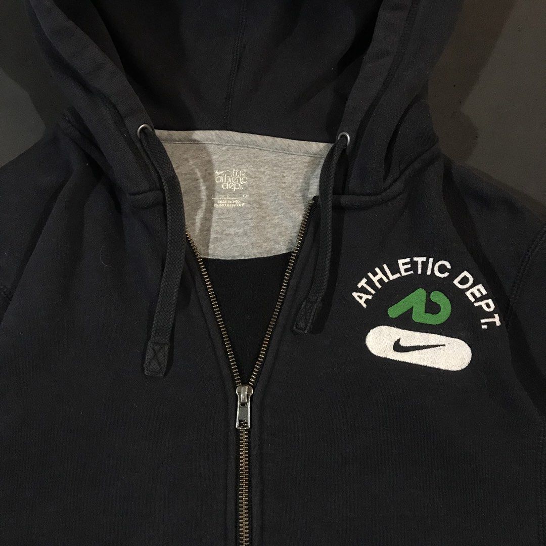 Nike Athletic Dept. Full-Zip Hoodie (Category: Coats, Jackets and Outerwear) located in Manila. Submitted by a_aron.f6e3a7 (Listing ID 1468783352, Image 3). Description: Size: L slim fit • Color rate: 9/10 (Black with White, Green, and Gray Logo Details) • Condition: Good pre-owned condition • Issues: Visible wrinkles and creases; no obvious major holes, tears, or heavy stains.