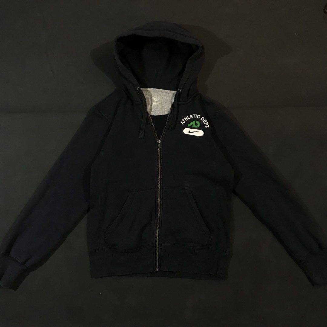 Nike Athletic Dept. Full-Zip Hoodie (Category: Coats, Jackets and Outerwear) located in Manila. Submitted by a_aron.f6e3a7 (Listing ID 1468783352, Image 2). Description: Size: L slim fit • Color rate: 9/10 (Black with White, Green, and Gray Logo Details) • Condition: Good pre-owned condition • Issues: Visible wrinkles and creases; no obvious major holes, tears, or heavy stains.