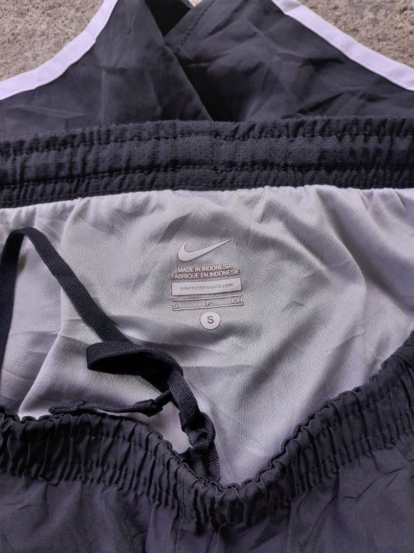 Nike Black Athletic Running Shorts Size S (Category: Shorts) located in Bayabas. Submitted by justhriftwithme (Listing ID 1468753587, Image 3). Description: - Brand: Nike - Item: Running Shorts - Color: Black with white trim - Size: Small (Tag intact) - Features: Elastic waistband with internal drawstring, inner lining for comfort - Details: Small silver swoosh logo near hem - Authenticity Code: 573728-010 - Origin: Made in Indonesia.