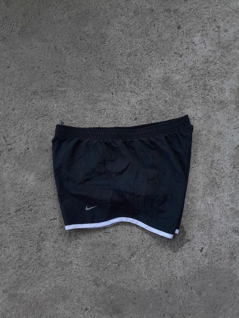 Nike Black Athletic Running Shorts Size S (Category: Shorts) located in Bayabas. Submitted by justhriftwithme (Listing ID 1468753587, Image 2). Description: - Brand: Nike - Item: Running Shorts - Color: Black with white trim - Size: Small (Tag intact) - Features: Elastic waistband with internal drawstring, inner lining for comfort - Details: Small silver swoosh logo near hem - Authenticity Code: 573728-010 - Origin: Made in Indonesia.