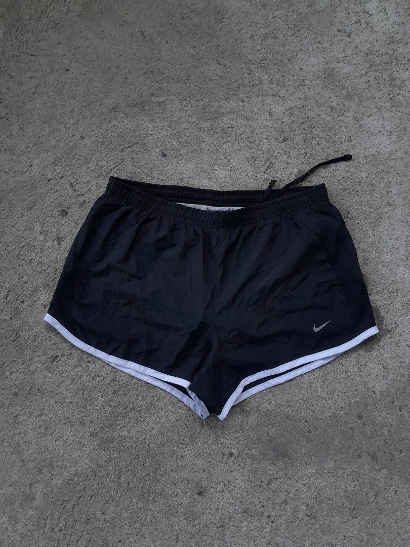 Nike Black Athletic Running Shorts Size S (Category: Shorts) located in Bayabas. Submitted by justhriftwithme (Listing ID 1468753587, Image 1). Description: - Brand: Nike - Item: Running Shorts - Color: Black with white trim - Size: Small (Tag intact) - Features: Elastic waistband with internal drawstring, inner lining for comfort - Details: Small silver swoosh logo near hem - Authenticity Code: 573728-010 - Origin: Made in Indonesia.