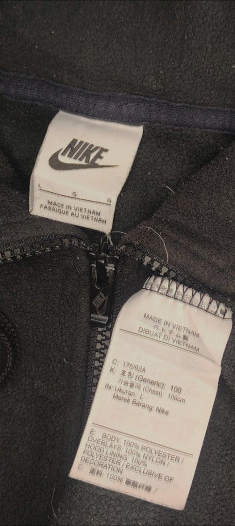 Nike Black Fleece Full-Zip Jacket Size L (Category: Coats, Jackets and Outerwear) located in Bulacan. Submitted by adrian2325 (Listing ID 1468782865, Image 3). Description: - Brand: Nike - Item: Fleece Jacket with Nylon Overlays - Color: Black with White Embroidered Swoosh - Size: Large (L) - Material: 100% Polyester (Made in Vietnam) - Features: Full zip closure, drawstring hood, and front pockets - Condition: Great classic piece for cooler weat