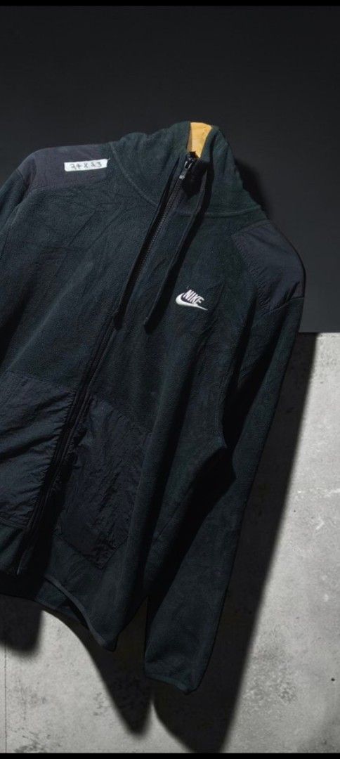 Nike Black Fleece Full-Zip Jacket Size L (Category: Coats, Jackets and Outerwear) located in Bulacan. Submitted by adrian2325 (Listing ID 1468782865, Image 2). Description: - Brand: Nike - Item: Fleece Jacket with Nylon Overlays - Color: Black with White Embroidered Swoosh - Size: Large (L) - Material: 100% Polyester (Made in Vietnam) - Features: Full zip closure, drawstring hood, and front pockets - Condition: Great classic piece for cooler weat