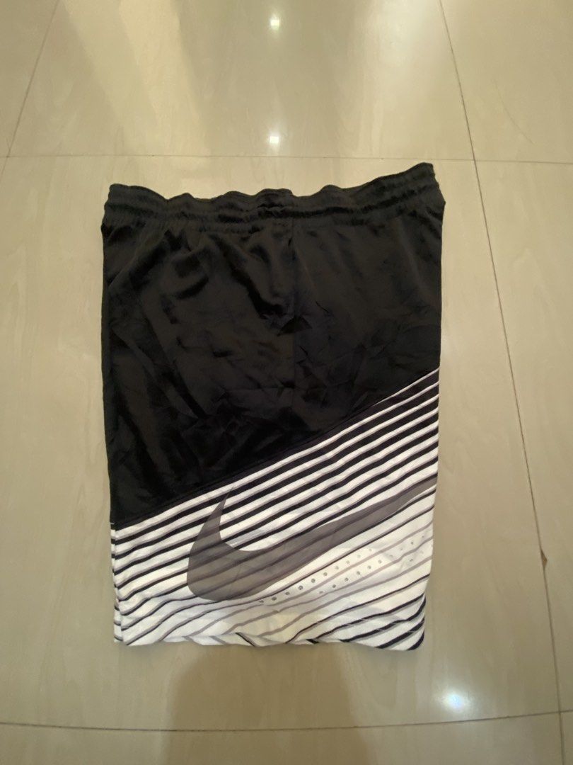 Nike Black White Striped Athletic Shorts (Category: Shorts) located in Vinzons. Submitted by gabrielvic (Listing ID 1468738639, Image 1). Description: - Brand: Nike - Style: Black and white striped athletic shorts (Style # 718387-010) - Logo: Large grey swoosh printed near the bottom hem - Fit: Elastic waistband with adjustable drawstring - Material: Lightweight and breathable - Ideal for: Gym workouts, running, or casual streetwear.