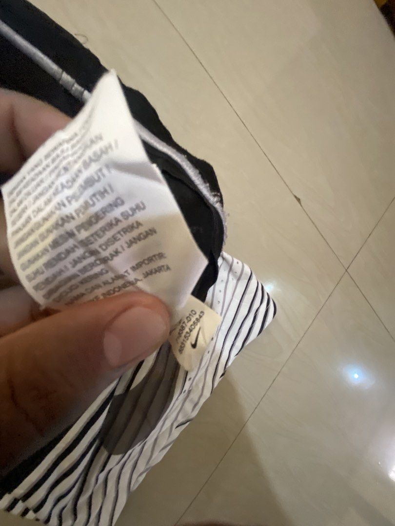 Nike Black White Striped Athletic Shorts (Category: Shorts) located in Vinzons. Submitted by gabrielvic (Listing ID 1468738639, Image 3). Description: - Brand: Nike - Style: Black and white striped athletic shorts (Style # 718387-010) - Logo: Large grey swoosh printed near the bottom hem - Fit: Elastic waistband with adjustable drawstring - Material: Lightweight and breathable - Ideal for: Gym workouts, running, or casual streetwear.