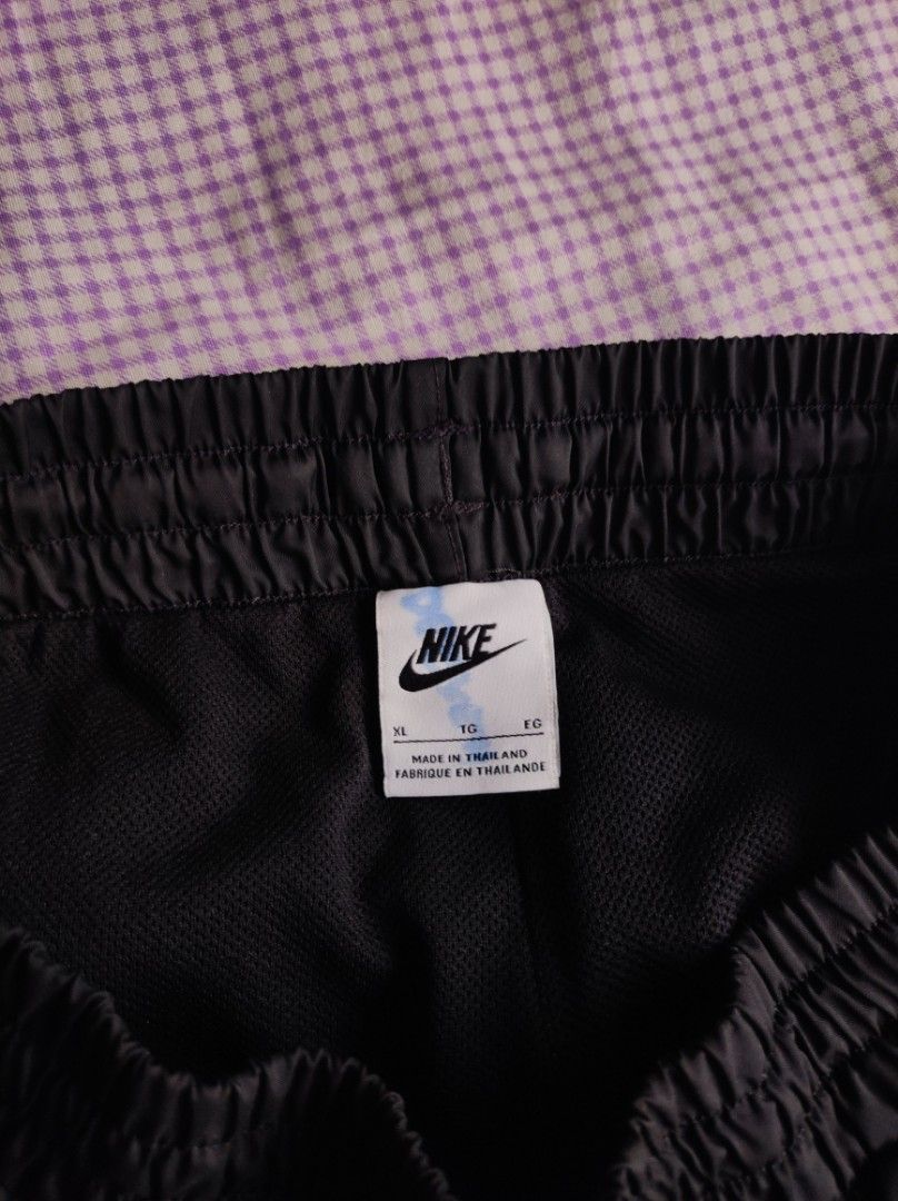 Nike Black Woven Shorts (Category: Shorts) located in Batangas. Submitted by astrofinds_ (Listing ID 1468717521, Image 2). Description: - Brand: Nike - Dimes: Waistline 26-34 / Length 18.5 / Hem - 11 - Size: XL (Made in Thailand) - Material: 100% polyester body and lining with lightweight mesh interior - Waistband: Elastic with comfortable stretch - Features: Large white Nike swoosh and lettering logo on left leg, plus convenient side pockets.