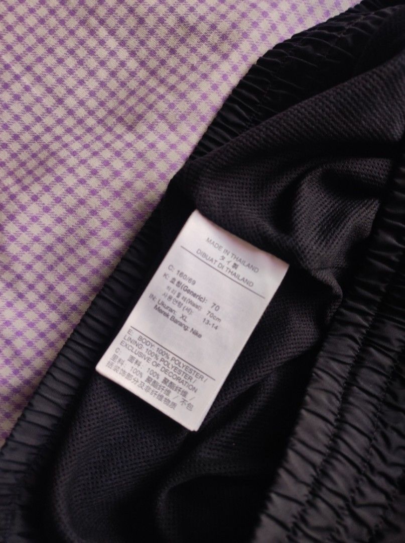 Nike Black Woven Shorts (Category: Shorts) located in Batangas. Submitted by astrofinds_ (Listing ID 1468717521, Image 3). Description: - Brand: Nike - Dimes: Waistline 26-34 / Length 18.5 / Hem - 11 - Size: XL (Made in Thailand) - Material: 100% polyester body and lining with lightweight mesh interior - Waistband: Elastic with comfortable stretch - Features: Large white Nike swoosh and lettering logo on left leg, plus convenient side pockets.