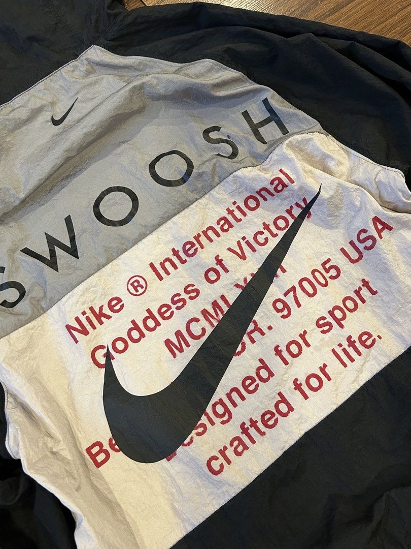 Nike Double Swoosh Windbreaker (Category: Coats, Jackets and Outerwear) located in Manila. Submitted by 144thrift_shits (Listing ID 1468727278, Image 3). Description: Nike Double Swoosh Windbreaker Size on tag:none Dimes: 22x27 Color rate: 9.5/10 Condition: 9.5/10 Issue: minimal crack prints (unnoticeable) 🏷️: 1600 + sf.