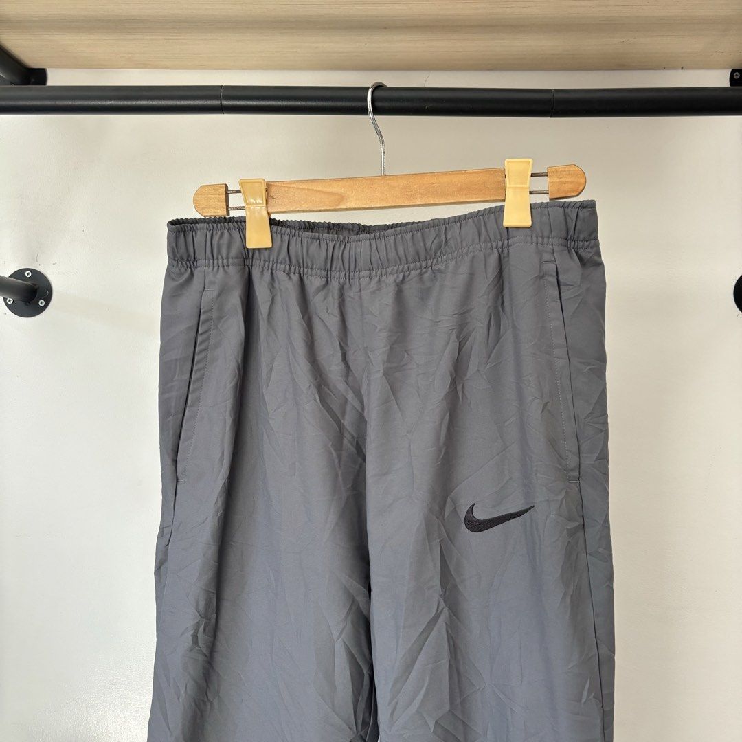 Nike Dri-FIT Grey Training Pants Size L (Category: Activewear) located in Bambang. Submitted by heats777 (Listing ID 1468817672, Image 1). Description: - Brand: Nike - Style: Dri-FIT Training Pants - Color: Grey with black Nike swoosh on left thigh - Size: Large (Best for waist 85cm, height 170-180cm) - Material: 100% Polyester - Features: Elastic waistband with internal drawstring, convenient side pockets - Condition: Brand new with material and