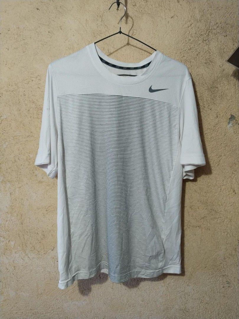 Nike Drifit Shirt (Category: Activewear) located in Cavite. Submitted by sacmaestro444 (Listing ID 1468772665, Image 1). Description: XXL on tag good condition small burn hole sa sleeve (see last photo) 9/10 colorate solid print.