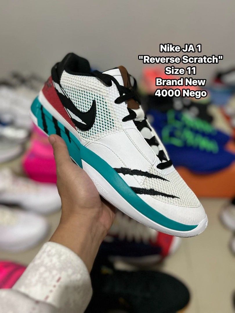 Nike JA 1 Reverse Scratch (Category: Sneakers) located in Quezon City. Submitted by bertsonamilasolidshoes (Listing ID 1468922112, Image 1). Description: - Model: Nike Ja 1 "Reverse Scratch" - Size: US 11 - Condition: Brand new, never worn, clean pair - Upper: White mesh with distinctive black claw marks - Details: Vibrant teal mudguard and striking red heel paneling - Perfect for ballers and sneakerheads looking to stand out on and off the court