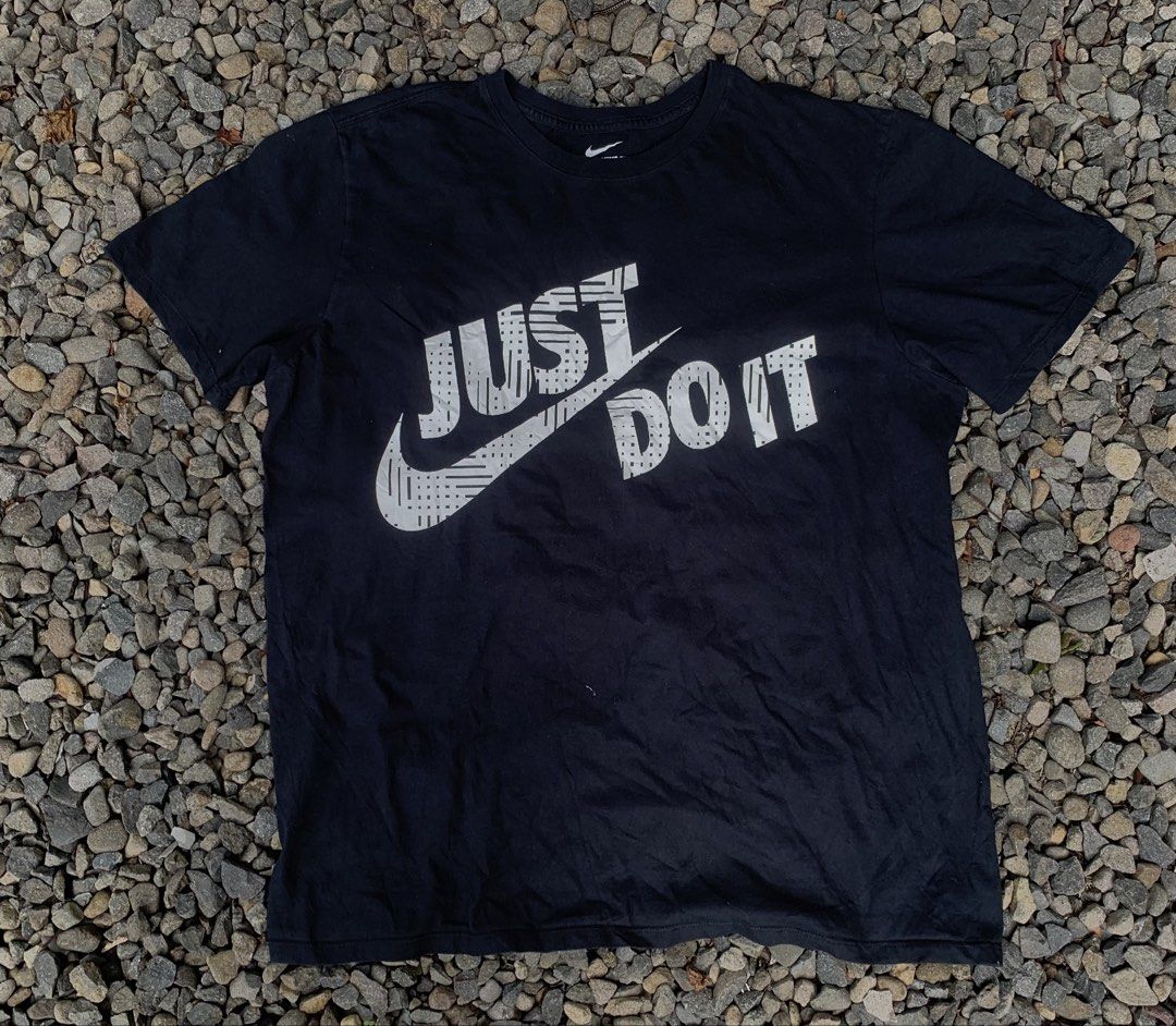 Nike Just Do It Black Graphic T-Shirt (Category: Tshirts & Polo Shirts ) located in Bacolod City. Submitted by lazythrifts (Listing ID 1468729068, Image 1). Description: - Brand: Nike - Color: Classic Black - Design: Signature 'Just Do It' chest graphic with stylish geometric pattern - Fit: Classic crew neck, short sleeves - Material: 100% soft and breathable cotton - Condition: Brand new / Excellent (ready to wear) - Style: Casual everyday stree