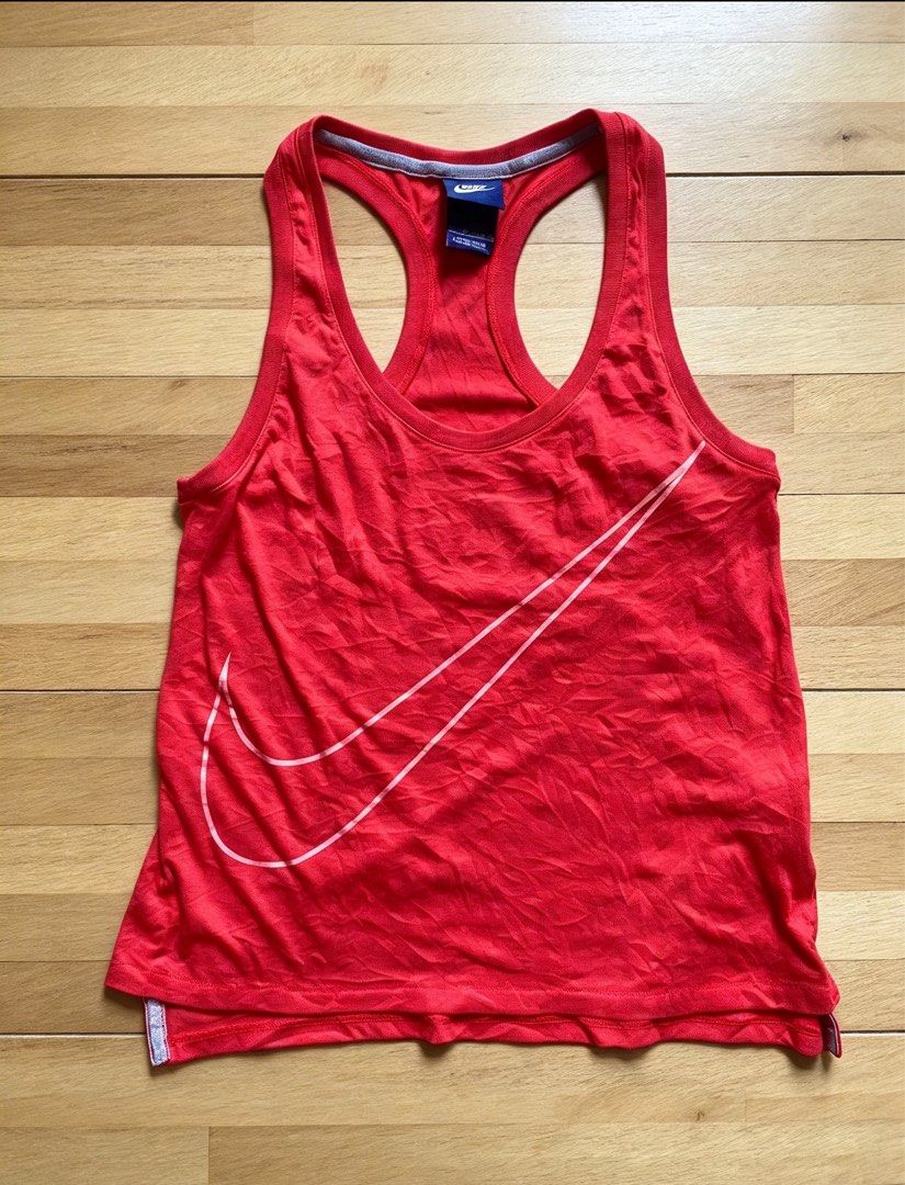Nike Red Racerback Tank Top (Category: Activewear) located in Manila. Submitted by tygaangub1096 (Listing ID 1468883478, Image 1). Description: - Brand: Nike - Style: Racerback tank top with classic scoop neckline - Color: Bright red with grey contrast trim - Design: Large pink outline swoosh logo on the front - Size: XS - Details: Made in China, includes fabric care tag with product code 642775-647 - Condition: Excellent - Add shipping fee .