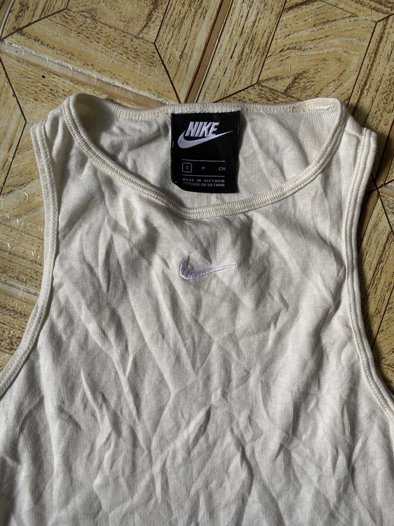 Nike Ribbed Tank Top Off White (Category: Activewear) located in Manila. Submitted by tygaangub1096 (Listing ID 1468883734, Image 2). Description: - Brand: Nike - Style: Ribbed racerback tank top - Color: Off-white - Size: Small - Details: Embroidered swoosh logo on chest - Material: Cotton blend with stretch - Condition: Clean, excellent, ready to wear - Add shipping fee .