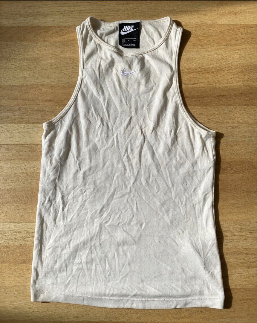 Nike Ribbed Tank Top Off White (Category: Activewear) located in Manila. Submitted by tygaangub1096 (Listing ID 1468883734, Image 1). Description: - Brand: Nike - Style: Ribbed racerback tank top - Color: Off-white - Size: Small - Details: Embroidered swoosh logo on chest - Material: Cotton blend with stretch - Condition: Clean, excellent, ready to wear - Add shipping fee .