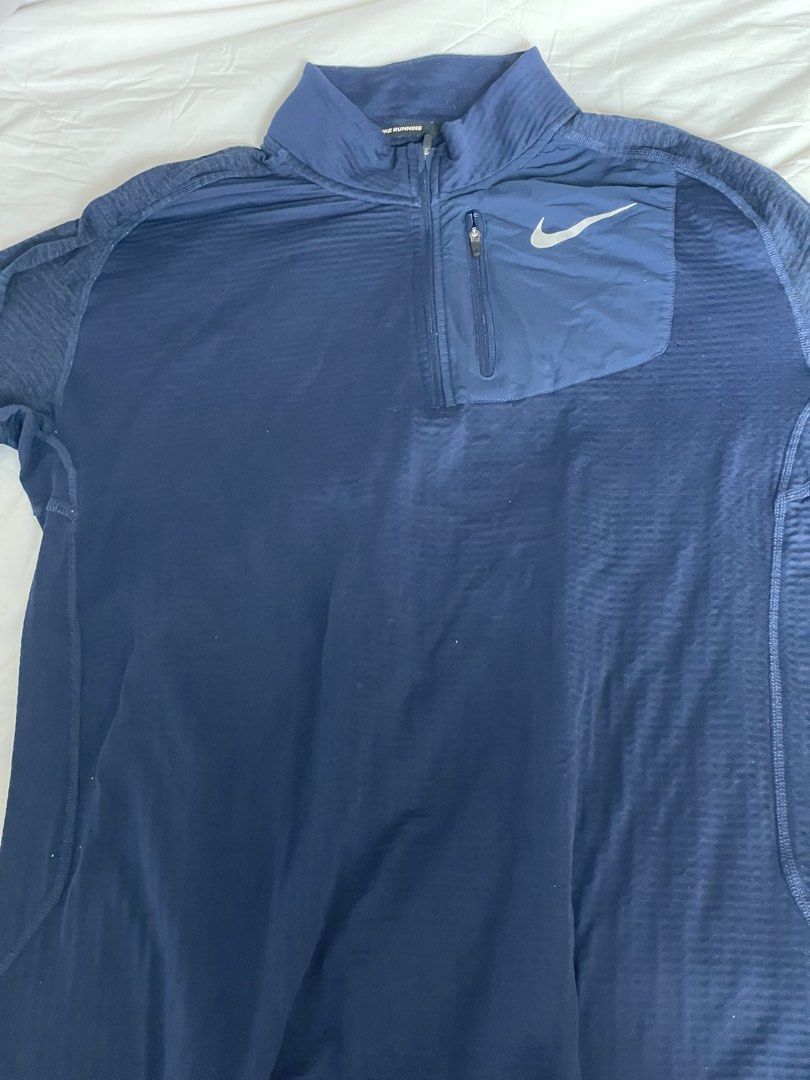Nike Running Dri-Fit Navy Blue Quarter Zip Pullover (Category: Coats, Jackets and Outerwear) located in Angono. Submitted by marketplacesellerph610 (Listing ID 1468744675, Image 1). Description: - Brand: Nike Running - Style: Quarter zip pullover - Color: Navy blue - Size: Large (Made in Thailand) - Material: Dri-fit with textured waffle grid interior - Features: Small upper left chest zip pocket with reflective Swoosh logo, inner collar taping -