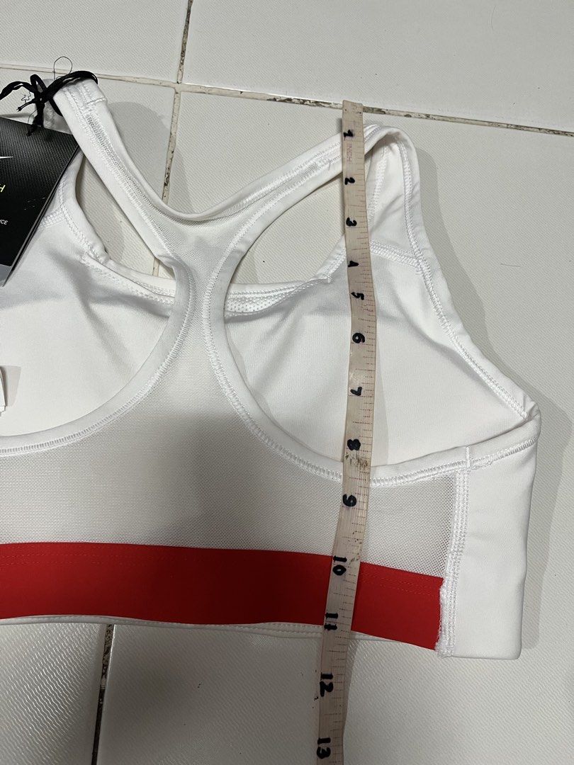 Nike Swoosh Medium Support Sports Bra White Medium (Category: Activewear) located in Manila. Submitted by cheng2007 (Listing ID 1468809797, Image 2). Description: - Brand: Nike - Style: Swoosh sports bra with red and blue graphic logo - Color: White - Size: Medium (approx. 12 inches across chest) - Support: Medium support with Dri-FIT technology - Features: Breathable mesh back panel - Condition: Brand new with original tags still attached 📍FLAW